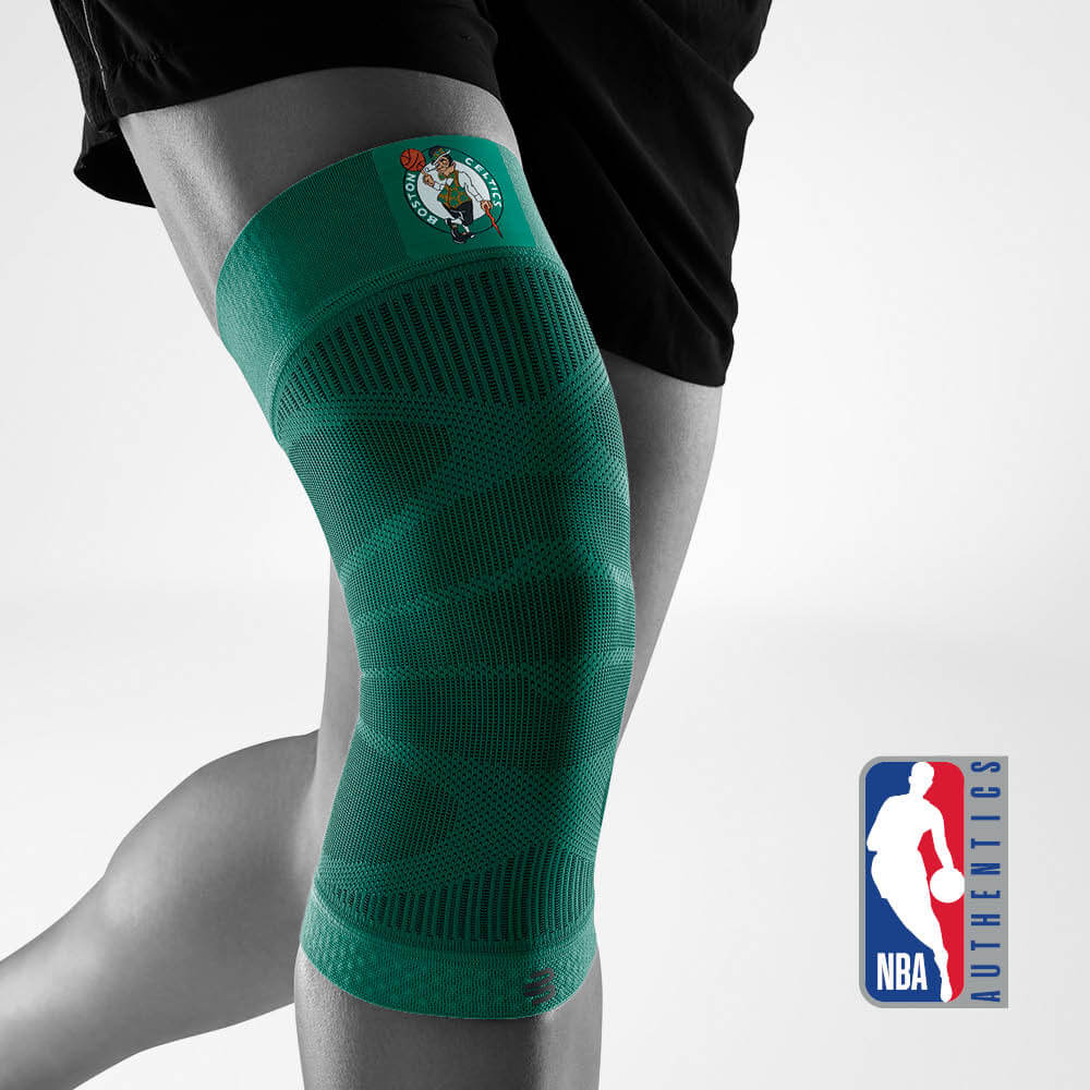 Boston Celtics knee brace with green compression fabric worn by an athlete with the NBA Authentics logo.