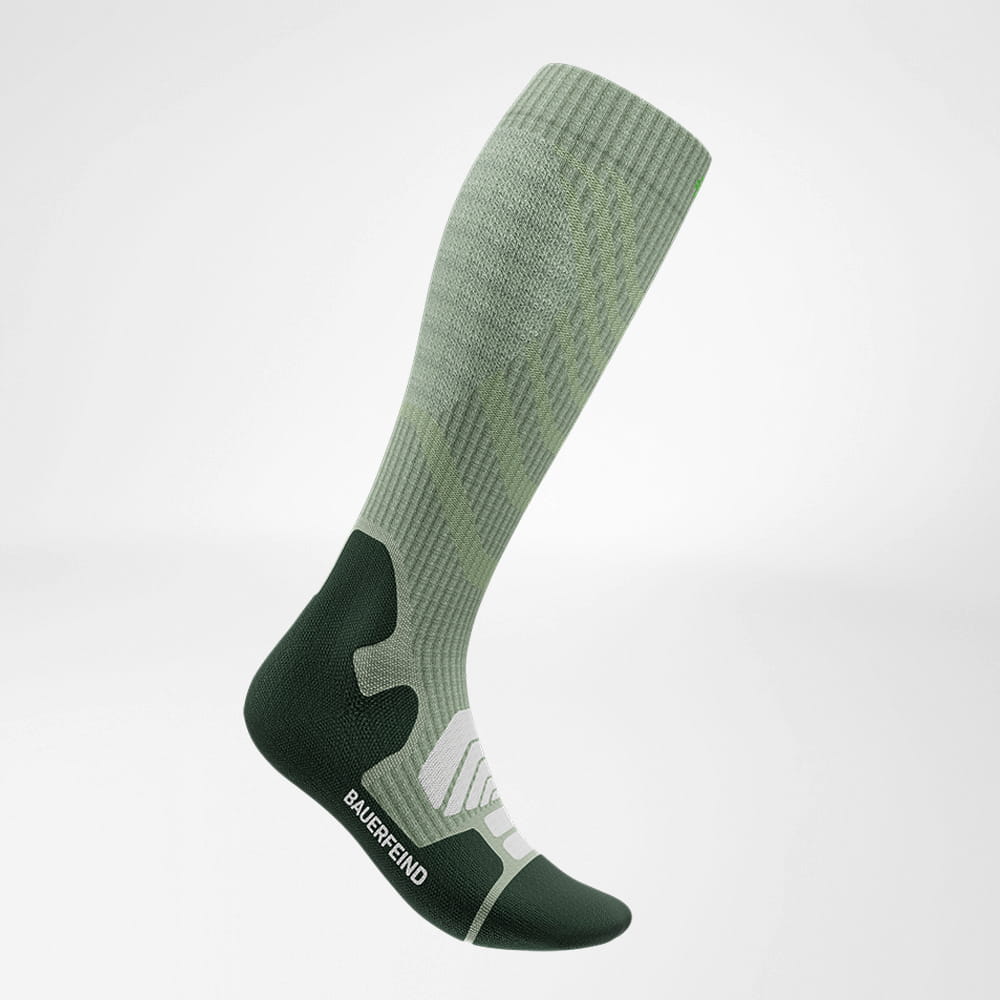 Green Bauerfeind compression sock for sports and athletic performance.