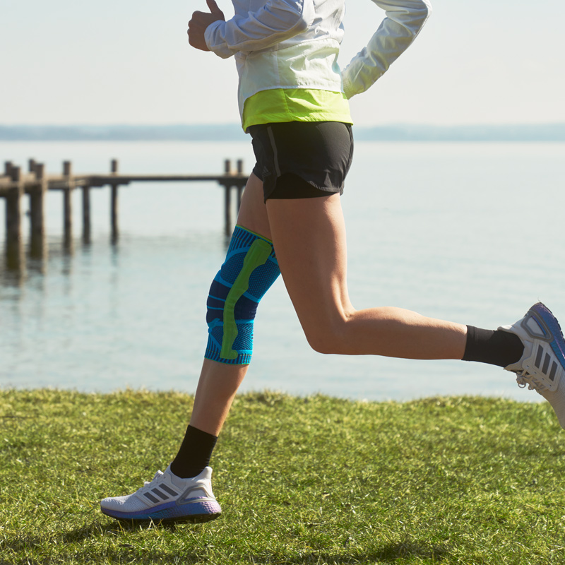 Woman running on a dock surrounded by a lake.