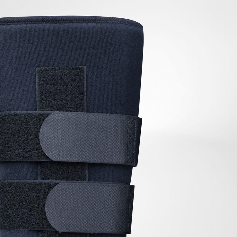 Close-up of a dark blue orthopedic support brace with adjustable velcro straps isolated on a light background.