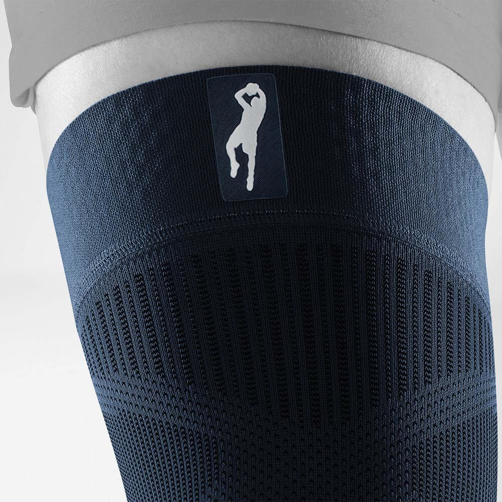 Close-up of a blue compression thigh sleeve with a silhouette logo at the top.