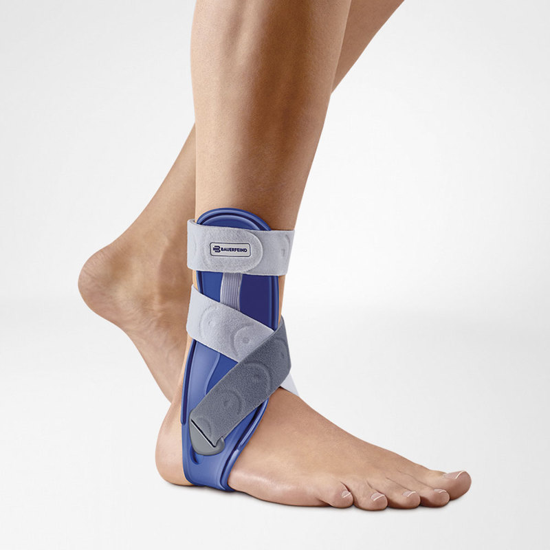 Close-up of a men wearing a blue and gray ankle stirrup brace for support and injury recovery