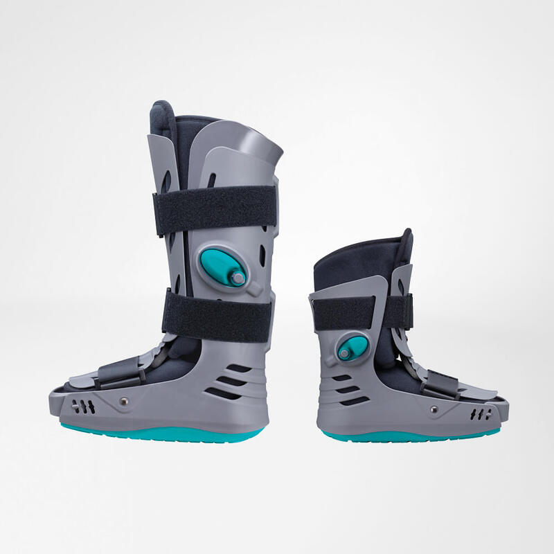 Close-up view of a modern, gray and turquoise knee brace highlighting its adjustable straps and sturdy support mechanism.