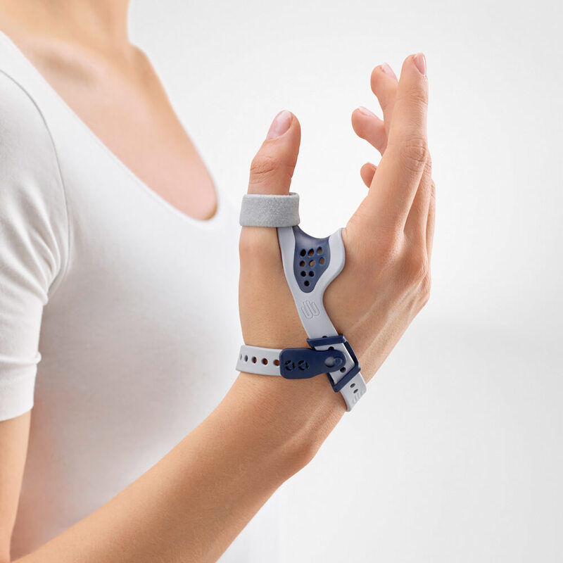 Close-up image of a woman wearing Bauerfeind's RhizoLoc OA arthritis thumb brace in front of a gray background.