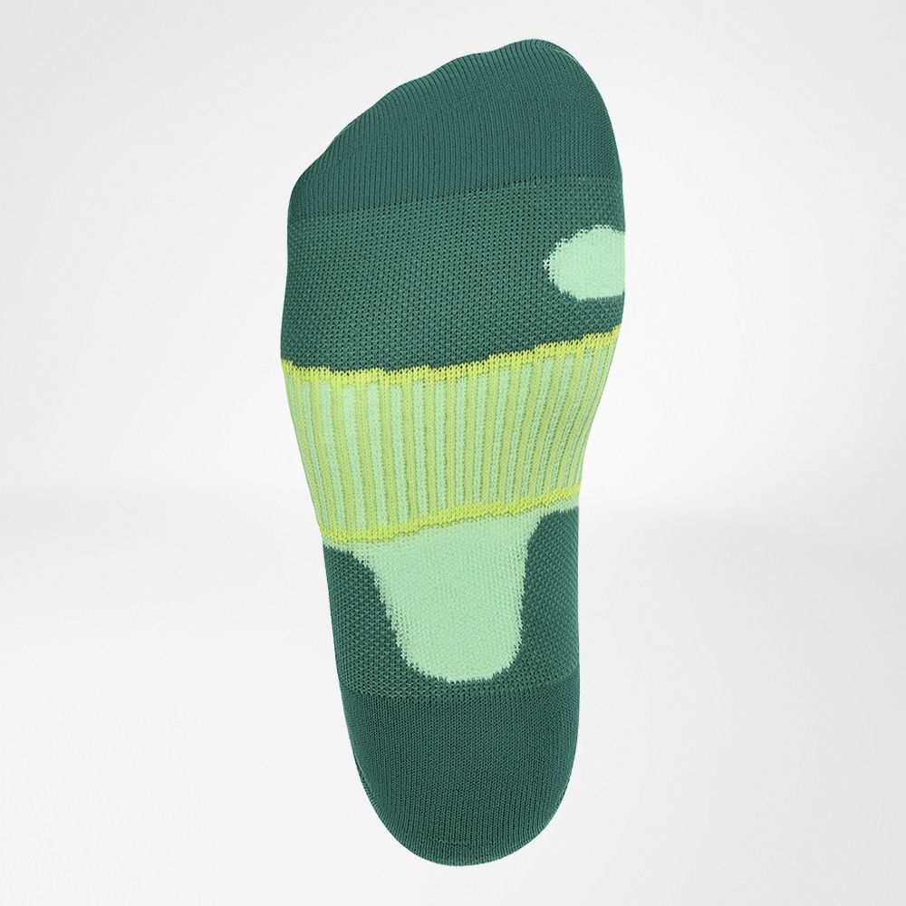 High-performance green and yellow compression soccer sock displayed on a neutral background, showing foot and ankle support zones.