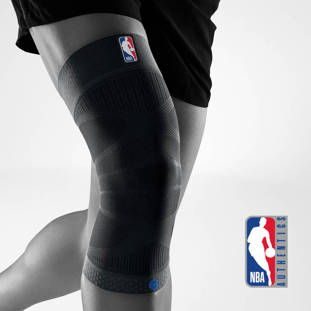 Close-up of NBA-branded knee sleeve on a person's leg, ideal for basketball support and compression.