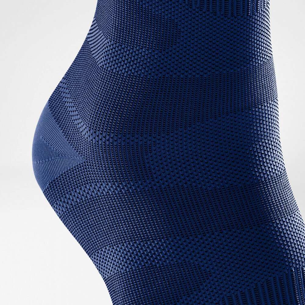 Close-up of blue textured knit fabric with intricate patterns.