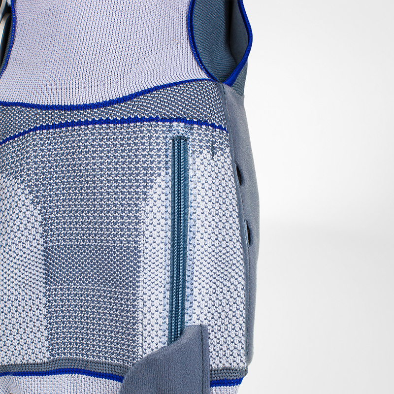 Close-up view of a blue and grey lightweight sports backpack featuring mesh textures and a zippered pocket