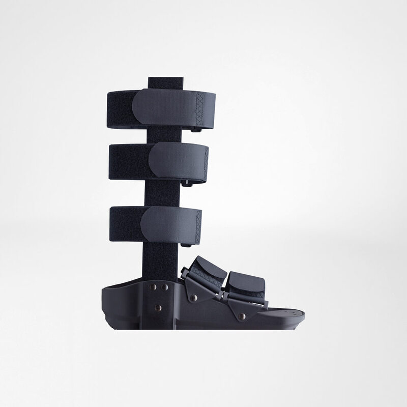 Black designer sandal with multiple adjustable straps displayed against a clean, grey background.