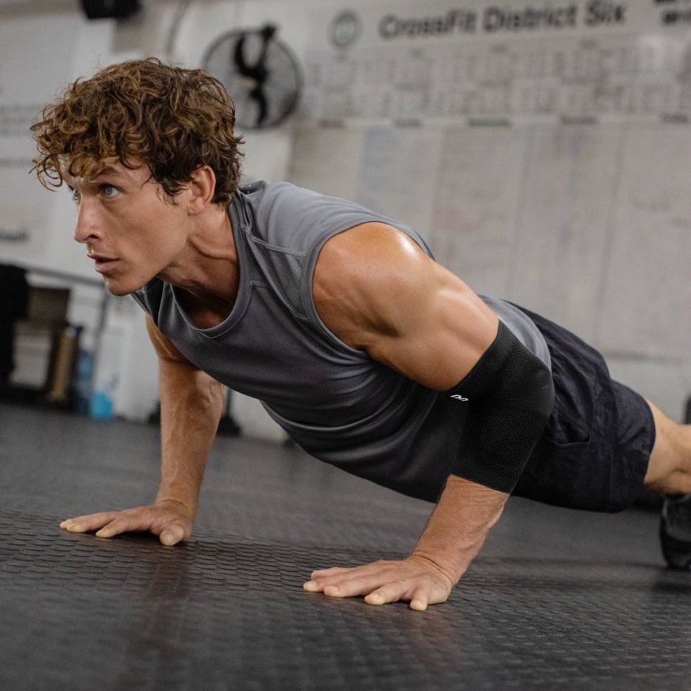 Image of man performing push-up wearing Sports Elbow Support