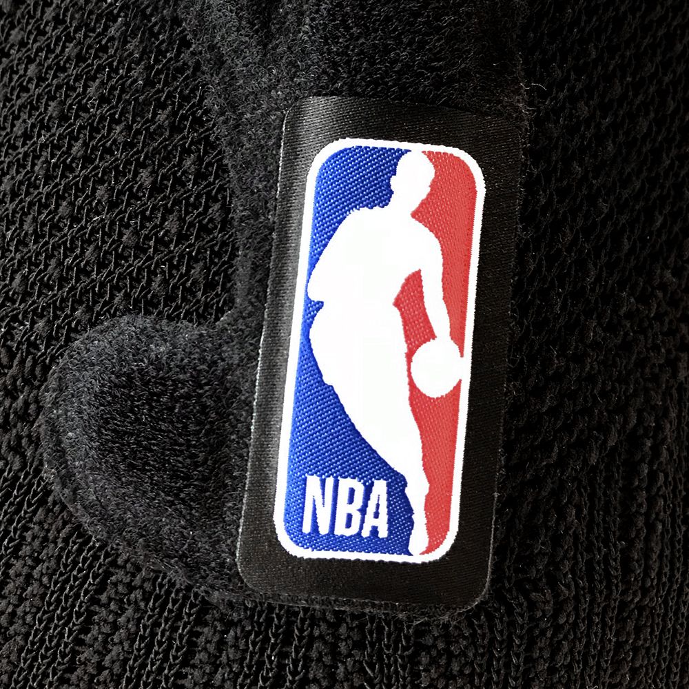 Close-up of NBA logo patch on black textured fabric