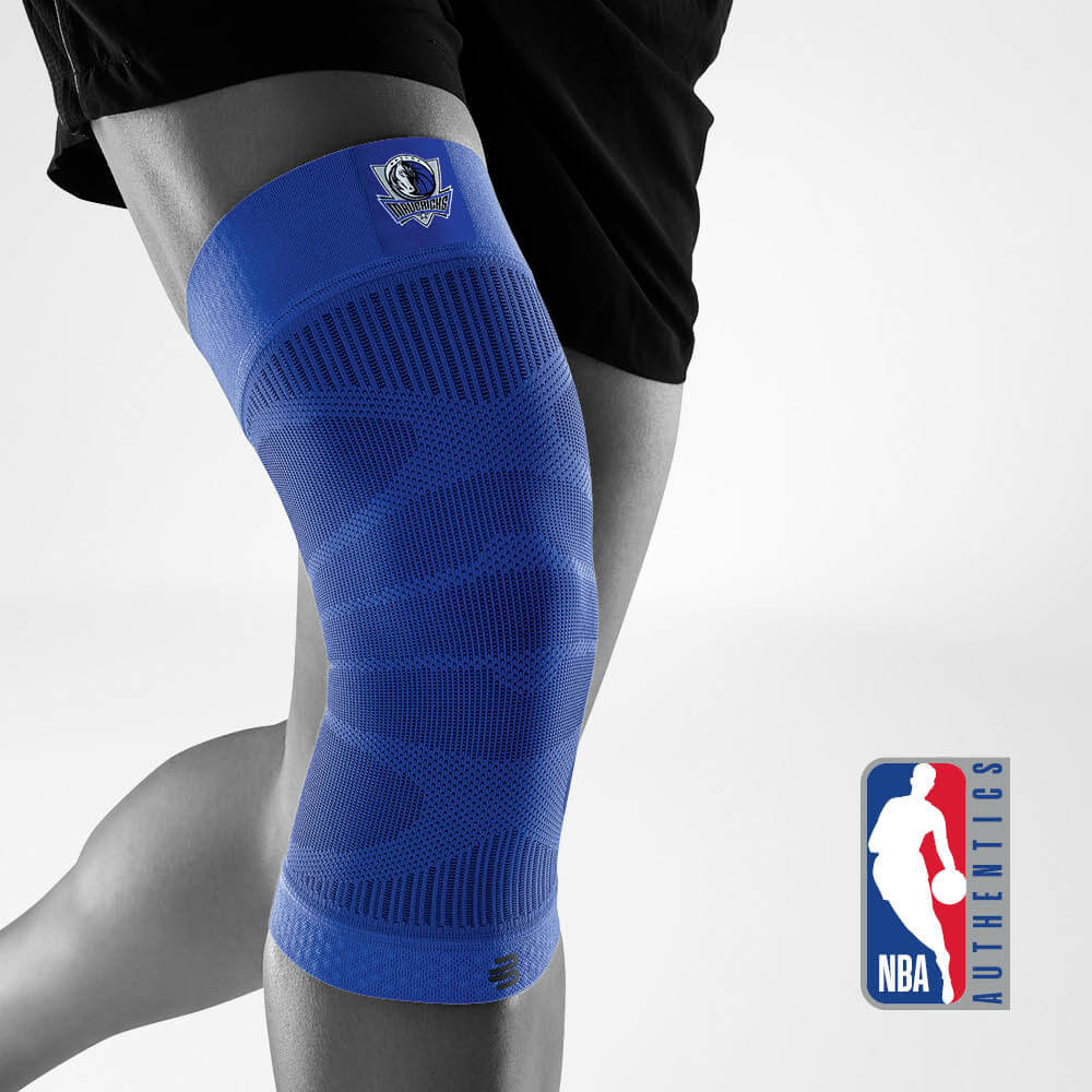 Bauerfeind's Sports Compression Knee Support NBA Mavericks Edition with NBA Authentics logo in the background.