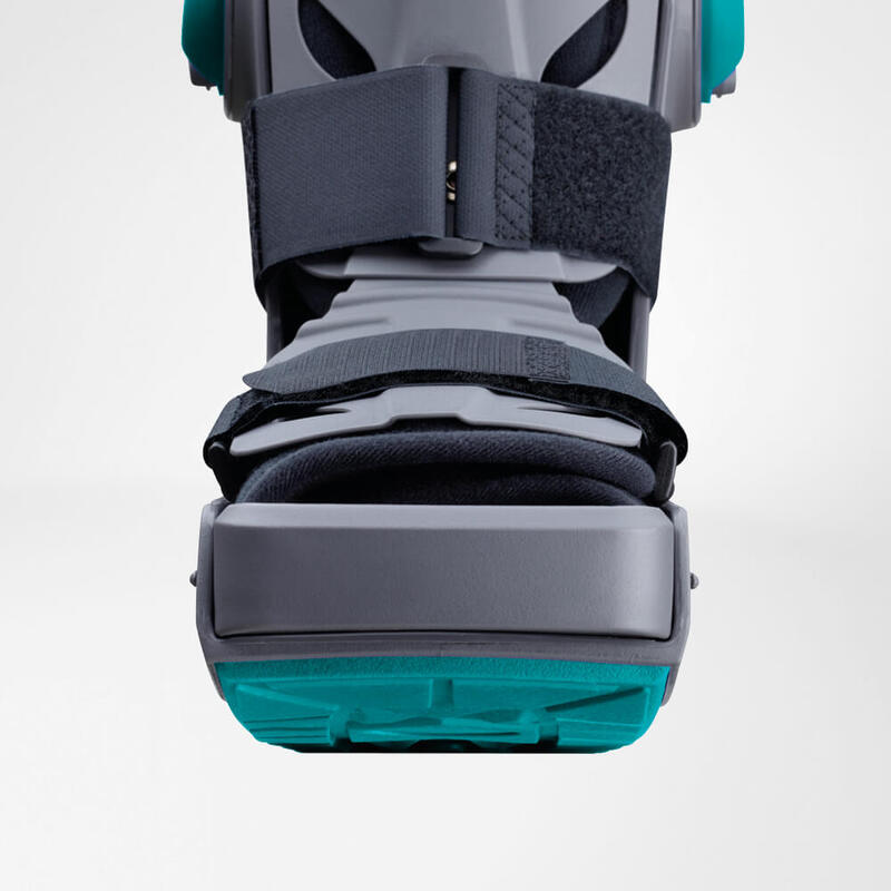 Close-up view of a modern, gray and turquoise knee brace highlighting its adjustable straps and sturdy support mechanism.