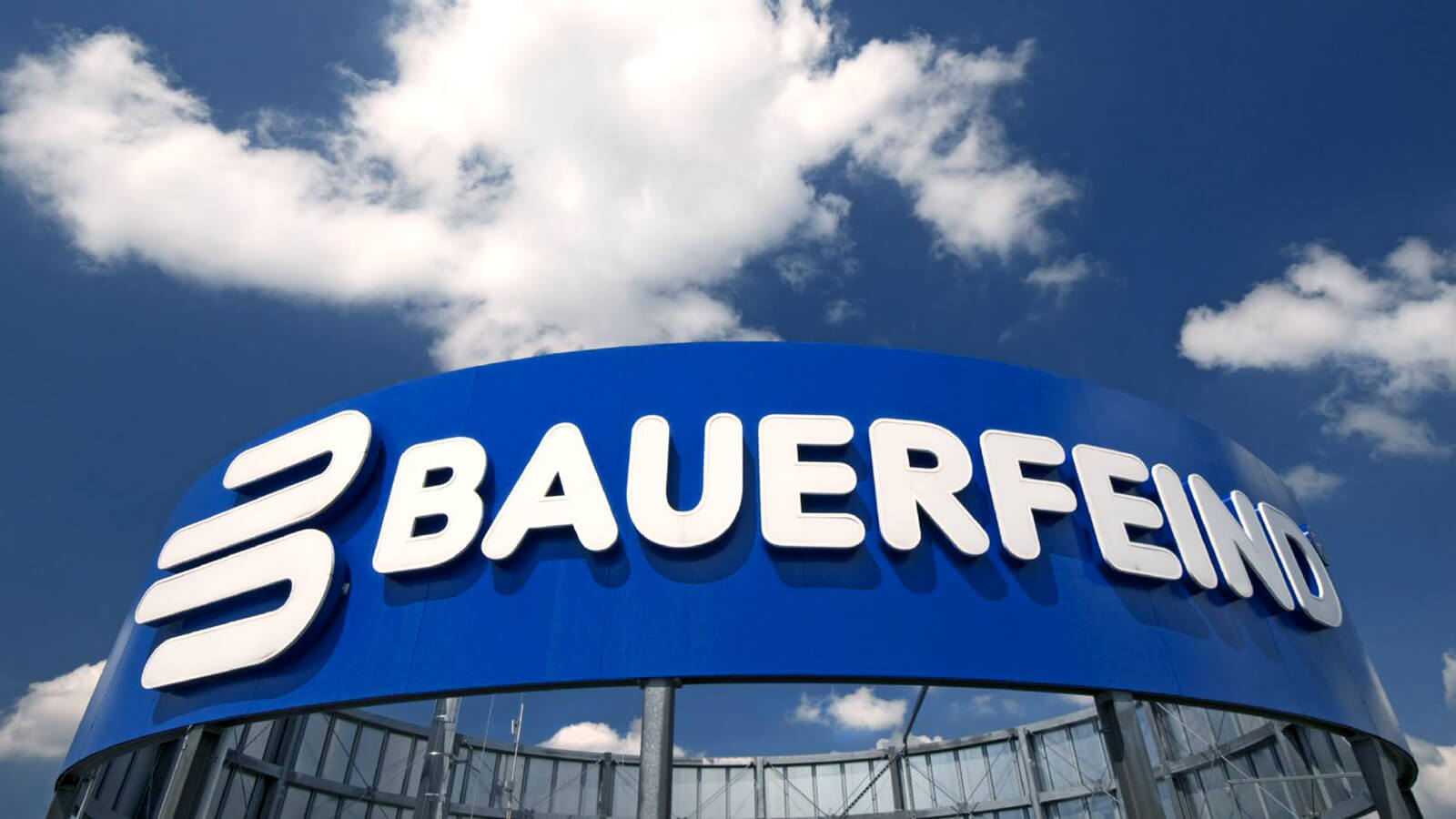 Bauerfeind signage located atop its main company headquarters in Germany, with a clouded sky in the background.