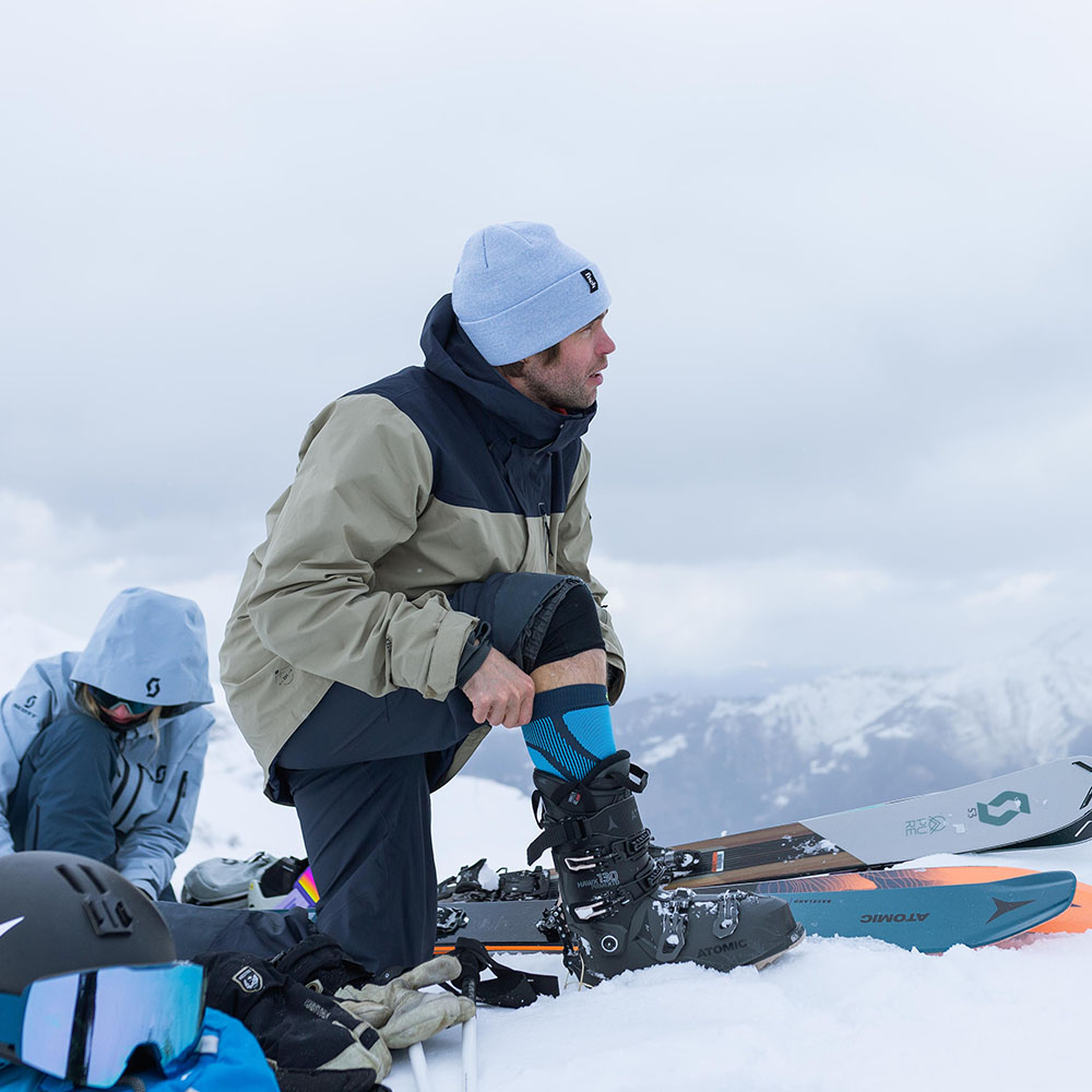 Image of two skiers preparing for day wearing Ski Performance Socks