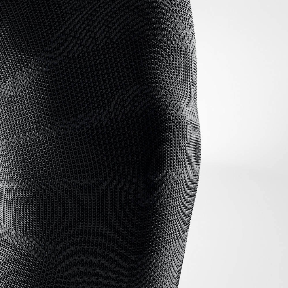 Close-up of black textured fabric with a modern, geometric pattern.