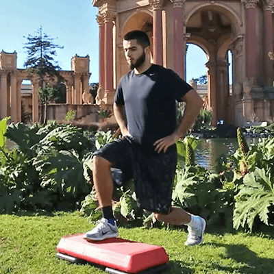 Young man performing the step up to a lunge exercise outside while wearing Bauerfeind's MalleoTrain ankle brace.