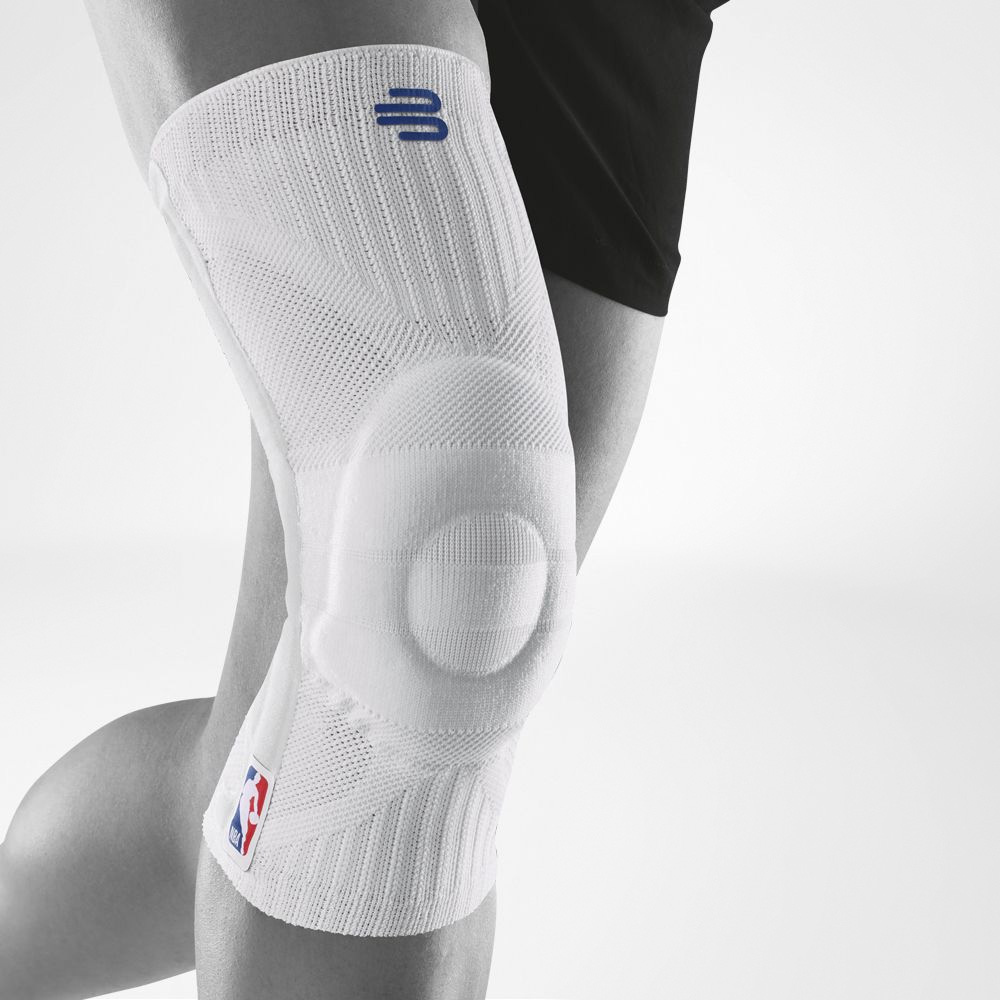 Close-up of person wearing a white knee brace with NBA logo