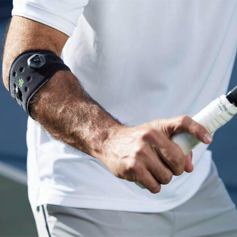 Image of man playing tennis wearing the Sports Elbow Strap