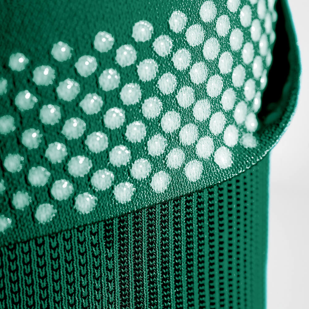 Close-up of the silicone-dotted gripping zones found on Bauerfeind's Sports Compression Knee Support NBA Celtics Edition.