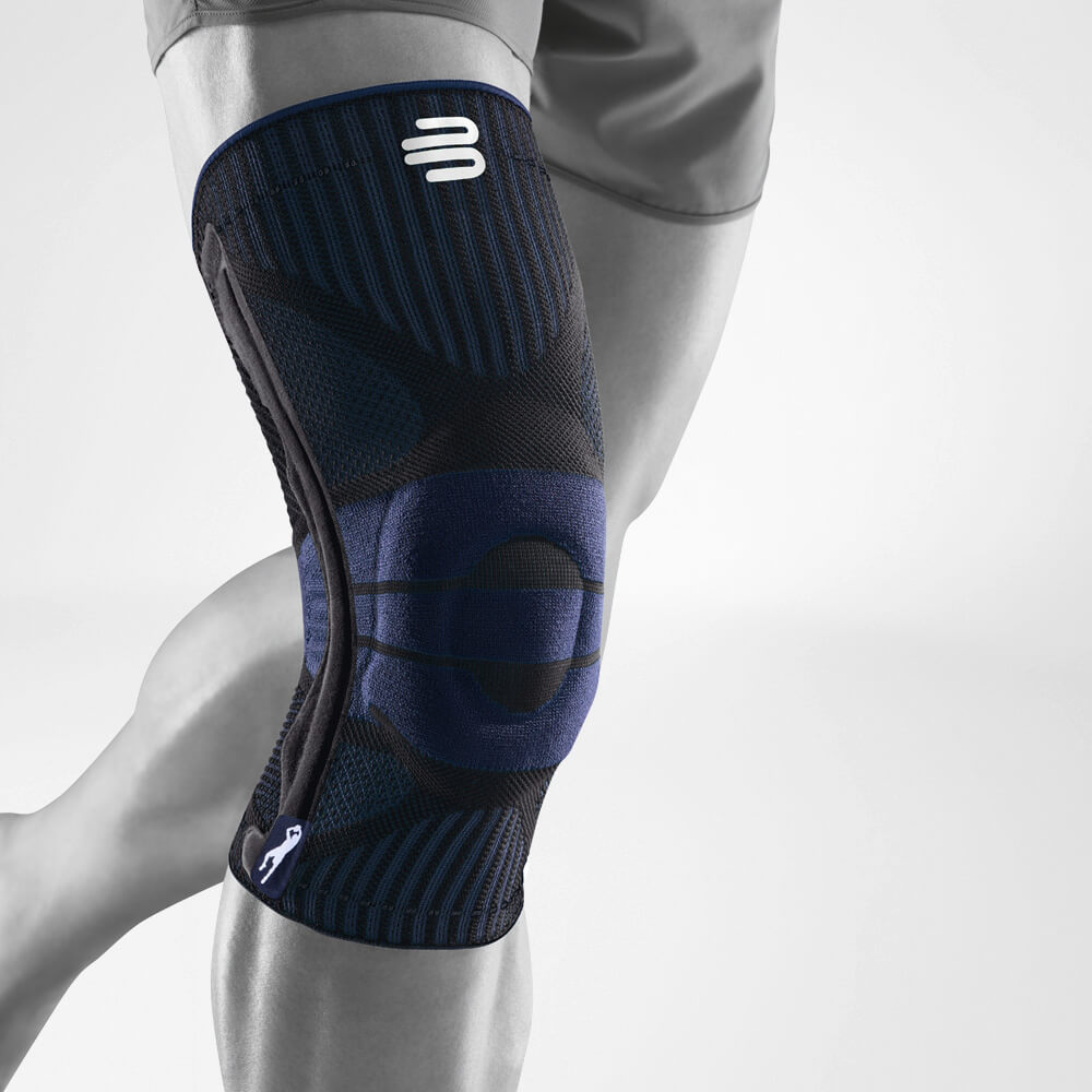 Close-up of a person wearing a black and blue knee brace for support during physical activity.