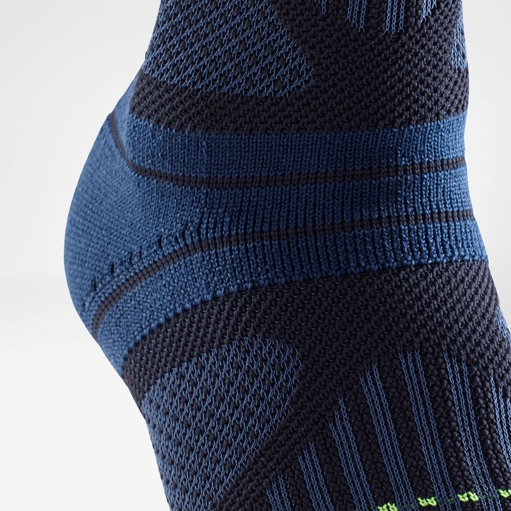 Close-up of a navy blue and black athletic sock with intricate knit patterns.