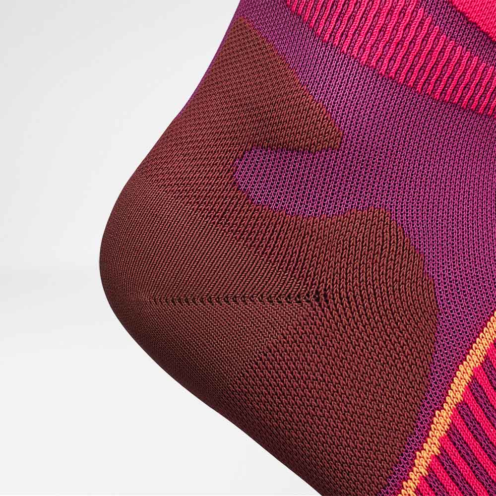 Close-up of a colorful, high-performance athletic sock with gradient red and purple threads.