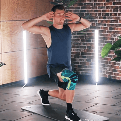 Olympic Gold Medalist Thomas Röhler performing lunge twists in a fitness studio while wearing Bauerfeind's Sports Knee Support.