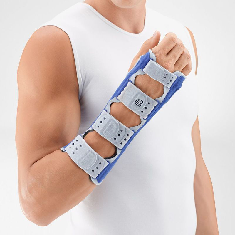 Close-up image of man wearing Bauerfeind's ManuLoc long wrist brace in front of a gray background.