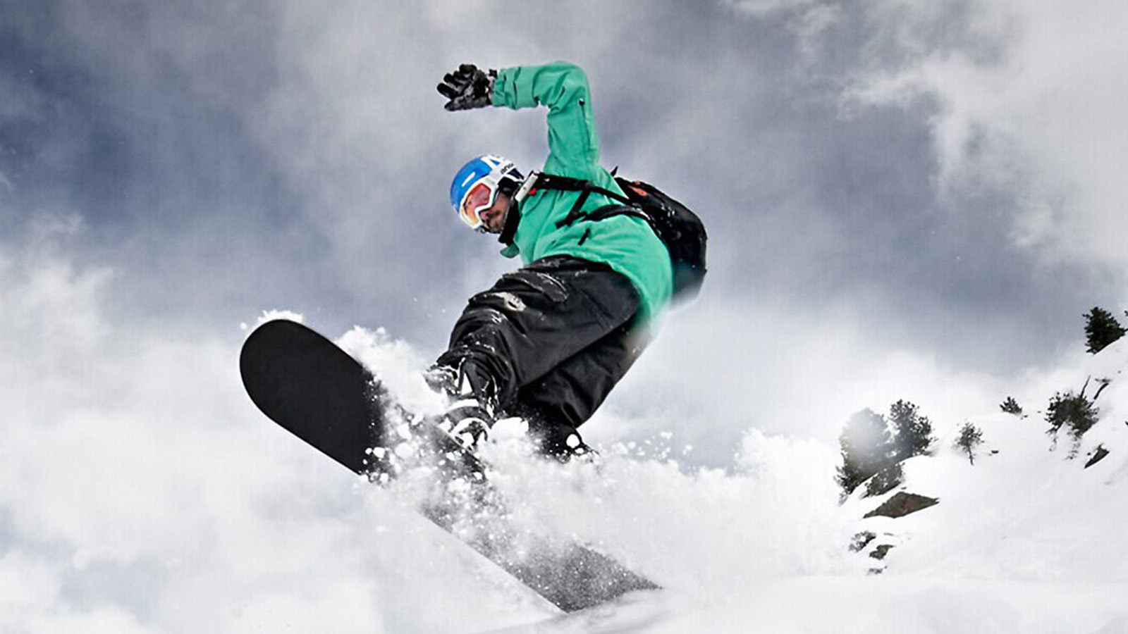 Woman skiing down a mountain slope wearing full ski gear and Bauerfeind's Sports Back Support, Sports Knee Support and Ski Performance Compression Socks.