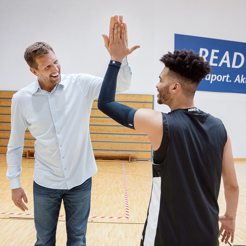 Image of high-five between men wearing Compression Sleeves Arm Dirk