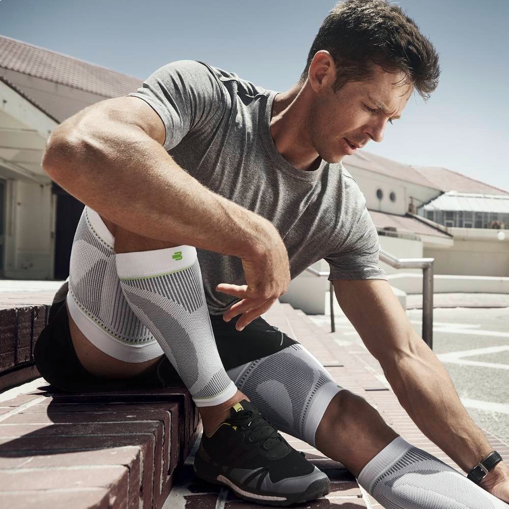 Image of athlete adjusting Compression Sleeves Lower Leg