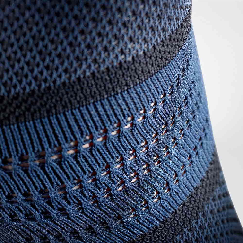 Close-up of blue and black athletic knit fabric with detailed stitching pattern